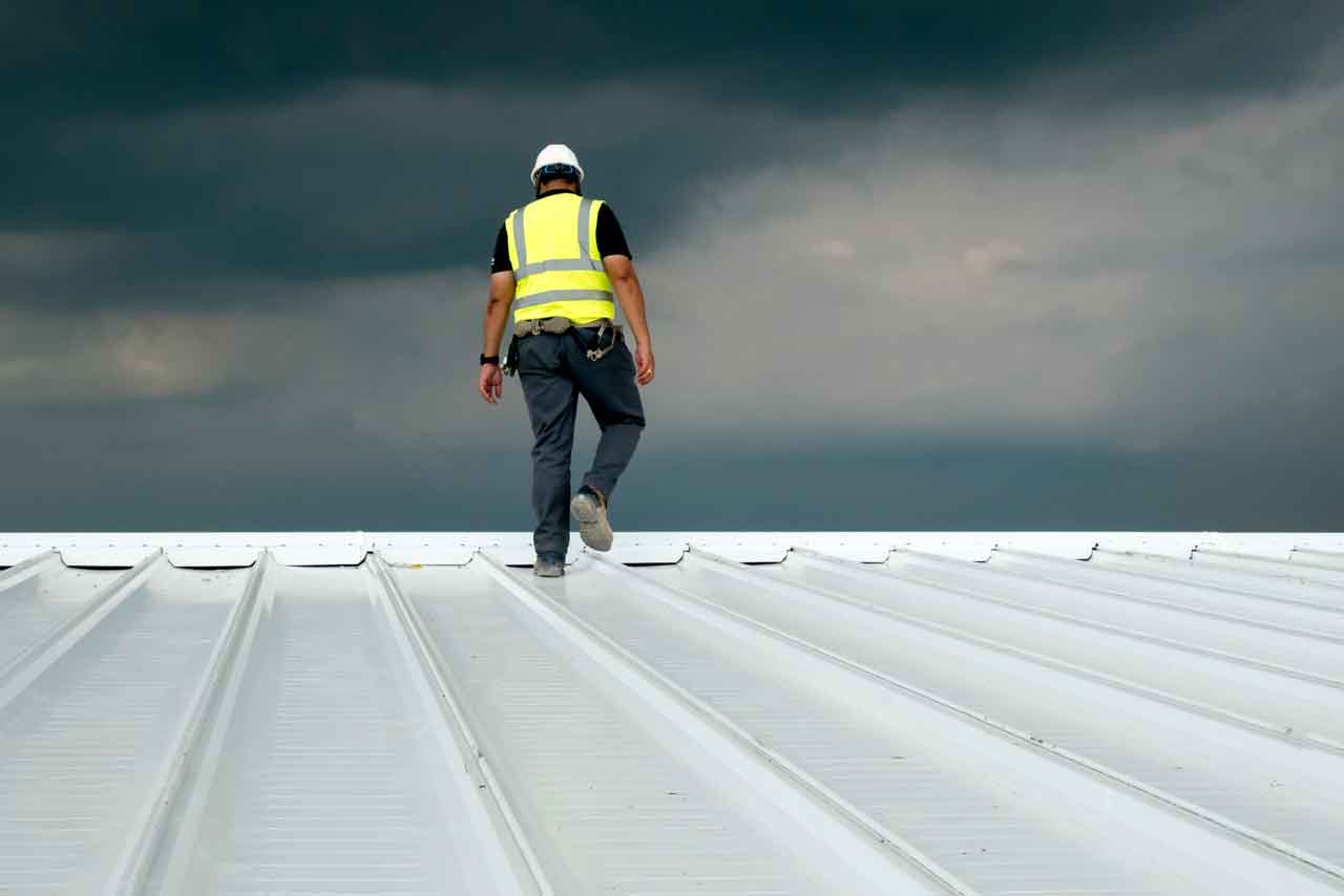 view of a residential roof on the Sunshine Coast being inspected by a professional