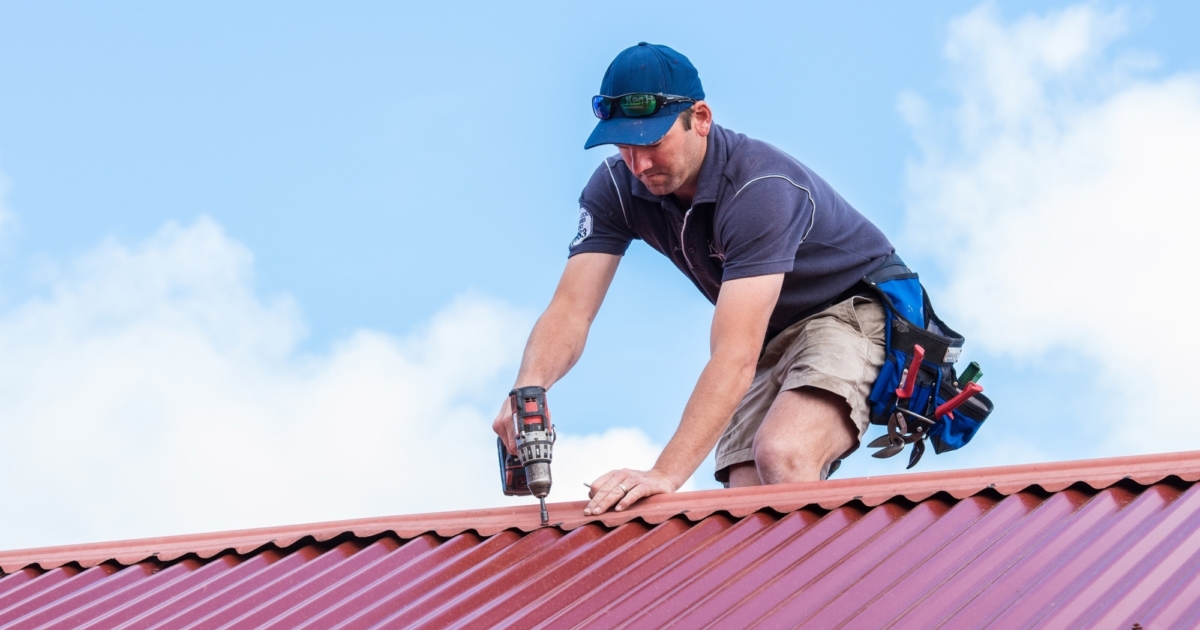 Roof maintenance technician inspecting a home's roof in Sunshine Coast.